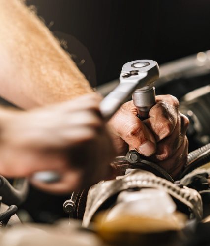 auto mechanic in car repair service with wrench